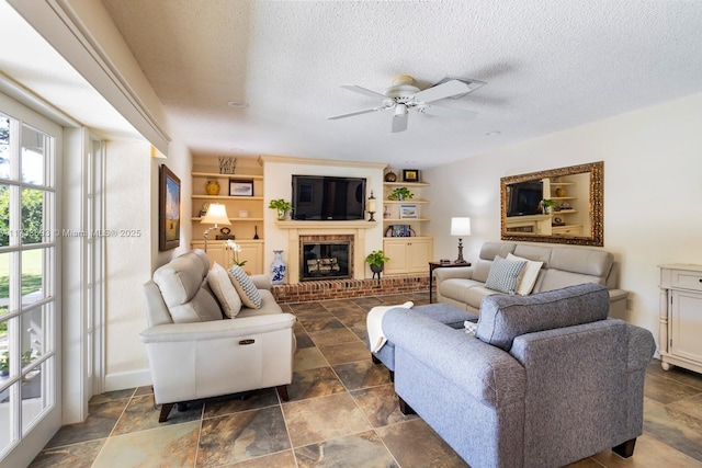 7420 SW 145th Ter, Palmetto Bay, FL 33158 - living room with ceiling fan, a textured ceiling, and a fireplace