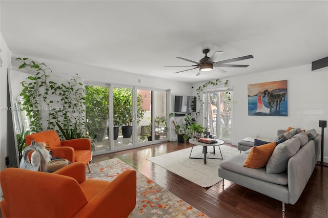 living room with ceiling fan and dark hardwood / wood-style flooring