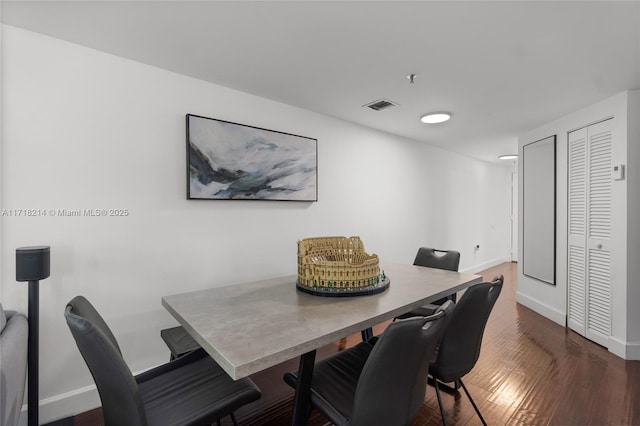 dining area with dark hardwood / wood-style floors