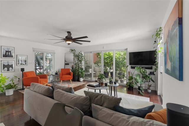 living room featuring dark hardwood / wood-style floors and ceiling fan