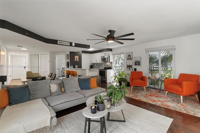 living room with dark hardwood / wood-style floors and ceiling fan