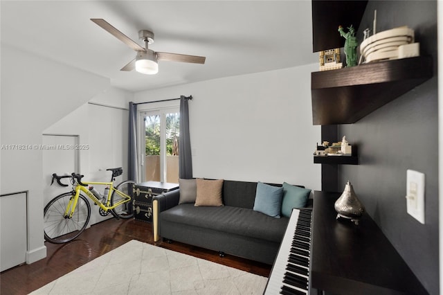 living room featuring hardwood / wood-style floors and ceiling fan