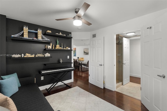 interior space with ceiling fan and wood-type flooring