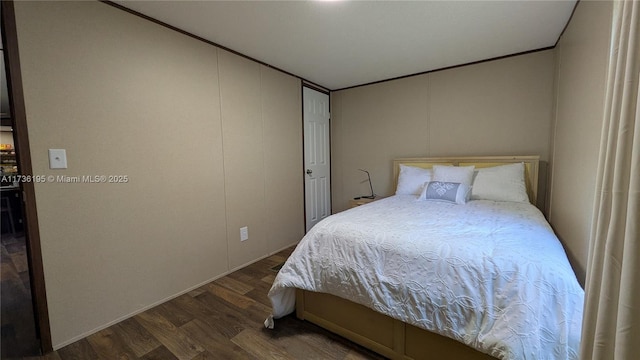 bedroom featuring ornamental molding and dark hardwood / wood-style floors