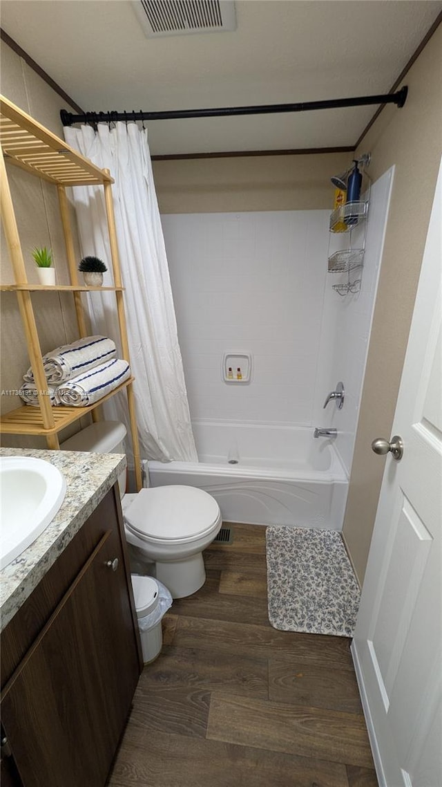 full bathroom featuring shower / tub combo with curtain, vanity, wood-type flooring, and toilet