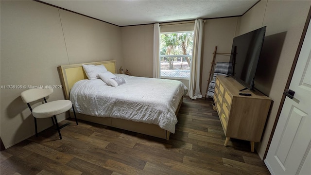 bedroom with ornamental molding, dark hardwood / wood-style floors, and a textured ceiling