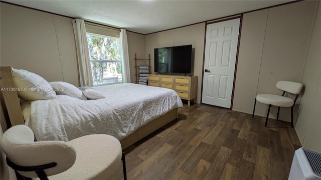 bedroom with dark hardwood / wood-style floors