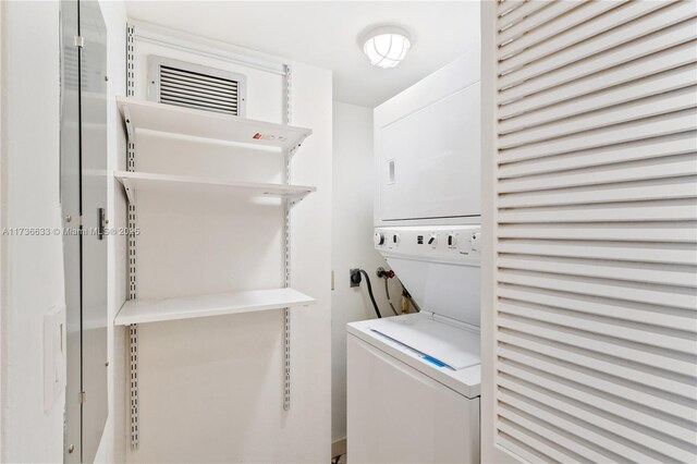 laundry room with stacked washer / dryer