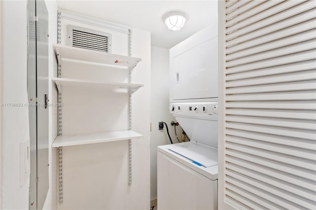 washroom with stacked washer and clothes dryer