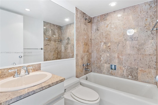 full bathroom with tiled shower / bath combo, vanity, and toilet