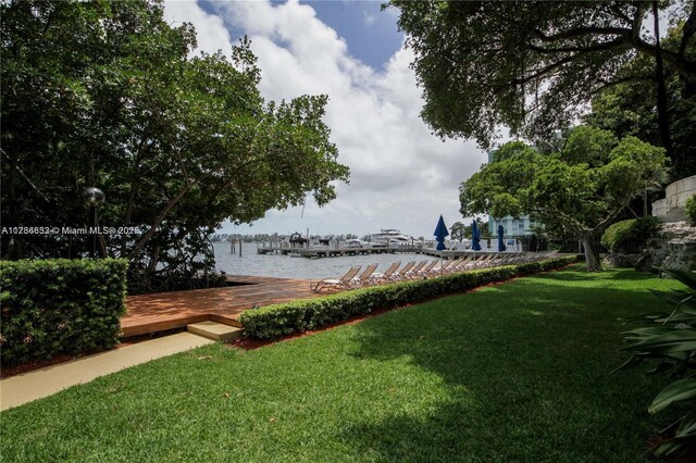 view of yard with a water view and a dock