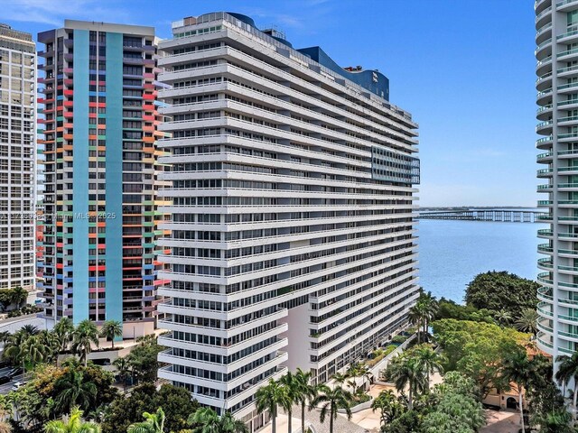 view of property featuring a water view and central AC unit