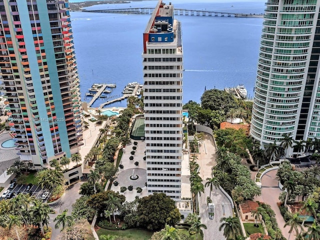 view of building exterior featuring a water view and central AC