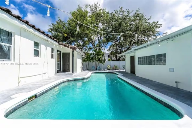 view of pool with a patio area, a fenced backyard, and a fenced in pool