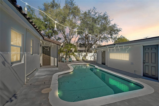 view of swimming pool with a fenced in pool and a patio