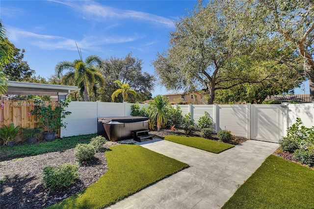 view of yard featuring a fenced backyard and a hot tub