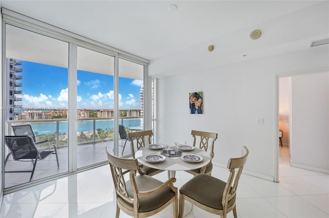 dining room featuring expansive windows and light tile patterned flooring