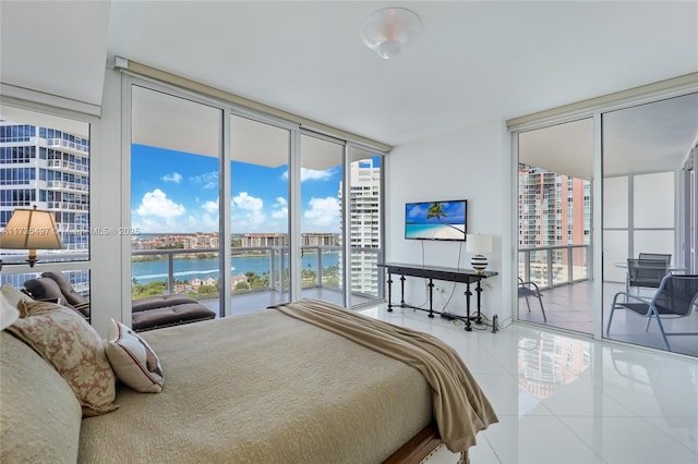 tiled bedroom with multiple windows, a wall of windows, and access to outside