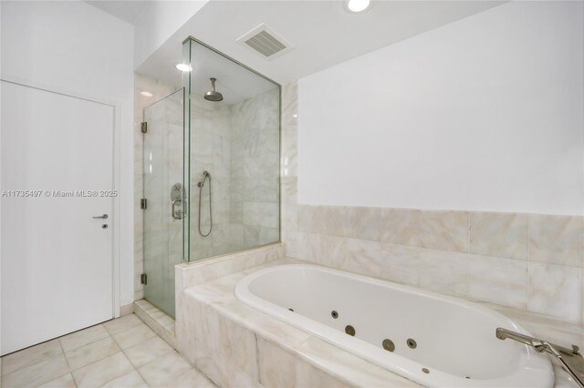 50 S Pointe Dr Unit 1704, Miami Beach, FL 33139 - full bath with a shower stall, a whirlpool tub, and tile patterned floors