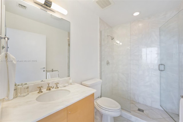 bathroom with vanity, toilet, and a shower with shower door