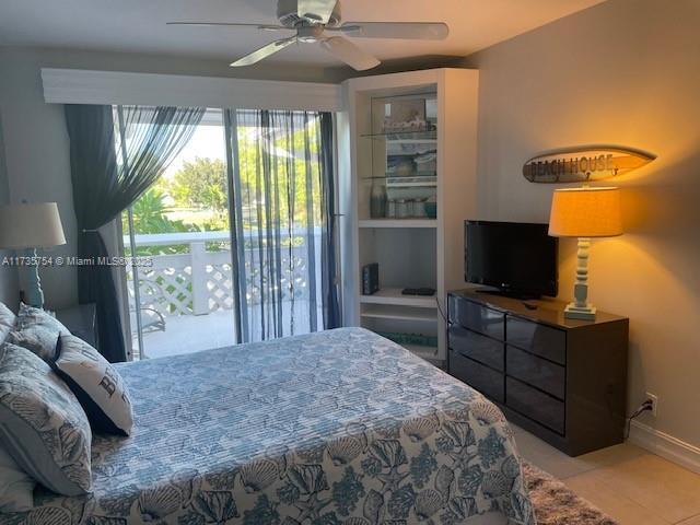 tiled bedroom featuring ceiling fan and access to outside