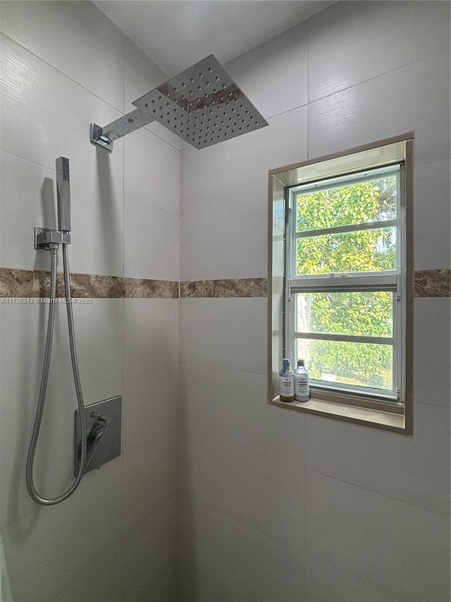 bathroom with a tile shower