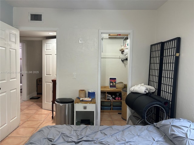 bedroom with light tile patterned flooring and a closet