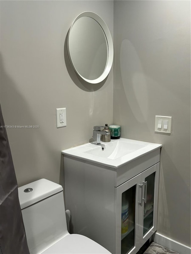 bathroom featuring vanity and toilet