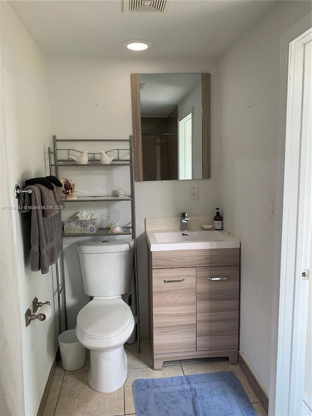 bathroom featuring tile patterned flooring, vanity, and toilet