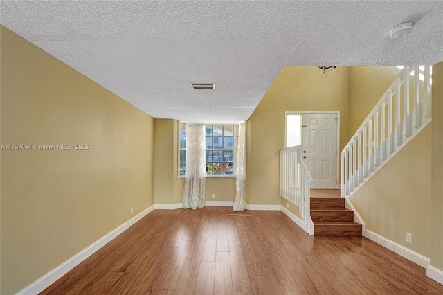 foyer featuring hardwood / wood-style floors and a textured ceiling