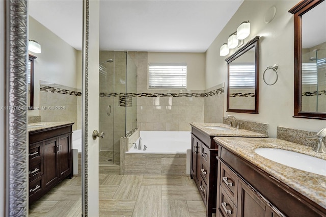 bathroom with vanity, plus walk in shower, and tile walls