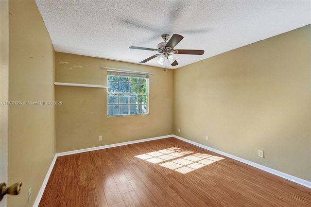 spare room with ceiling fan, hardwood / wood-style floors, and a textured ceiling