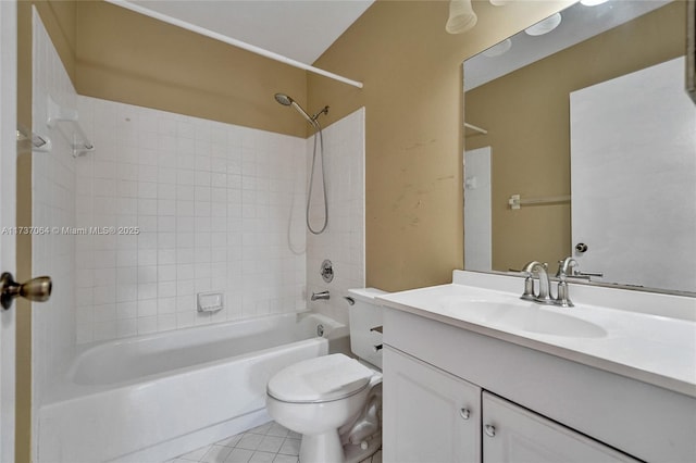 full bathroom featuring tiled shower / bath, tile patterned floors, toilet, and vanity