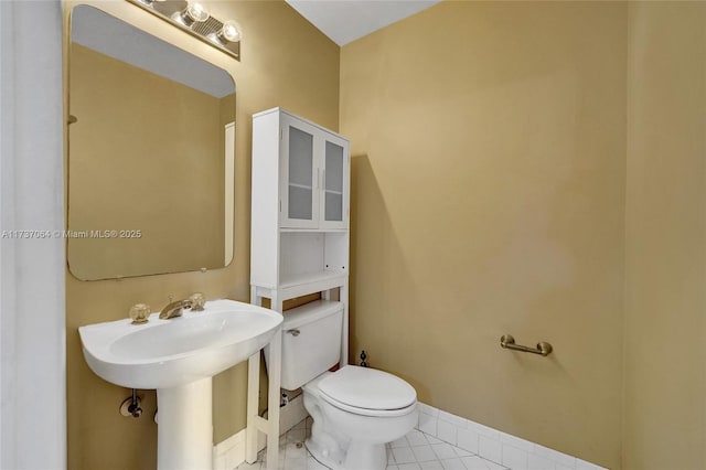 bathroom with sink, tile patterned floors, and toilet