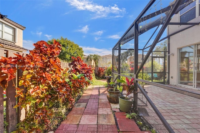 view of patio with glass enclosure