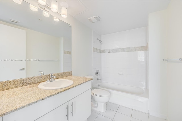 full bathroom with tiled shower / bath, vanity, toilet, and tile patterned flooring