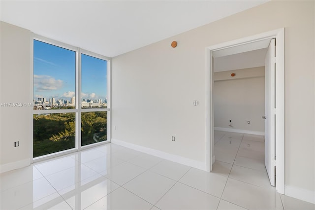 tiled spare room with floor to ceiling windows