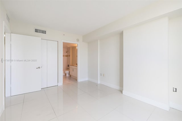 unfurnished room with light tile patterned floors