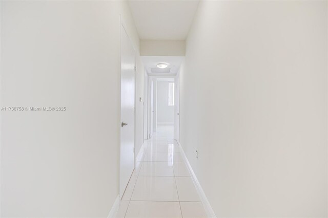 hall featuring light tile patterned floors