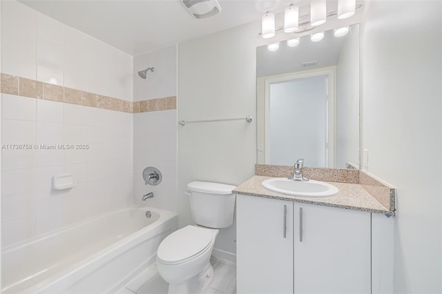 full bathroom with vanity, tiled shower / bath combo, and toilet