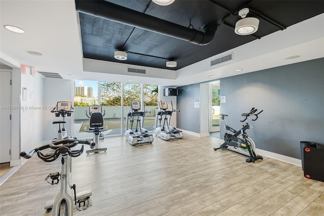 exercise room featuring light wood-type flooring