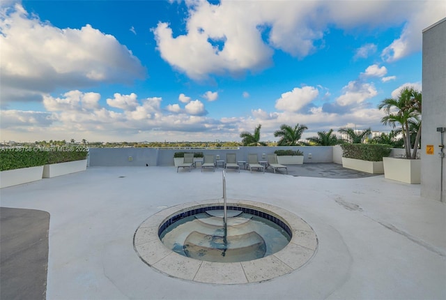 view of swimming pool featuring a patio area and an in ground hot tub