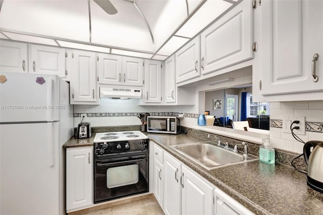 kitchen featuring sink, white cabinets, backsplash, white fridge, and electric stove