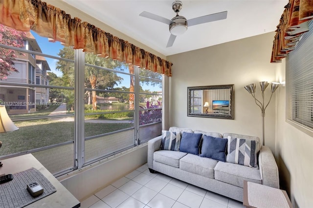 tiled living room with a wealth of natural light and ceiling fan