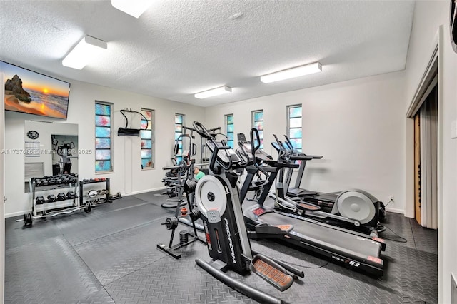 workout area featuring a textured ceiling