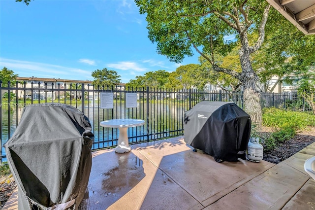 view of patio / terrace featuring a water view and grilling area