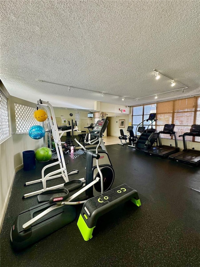 1000 Parkview Dr Unit 202, Hallandale Beach, FL 33009 - workout area featuring a textured ceiling and baseboards
