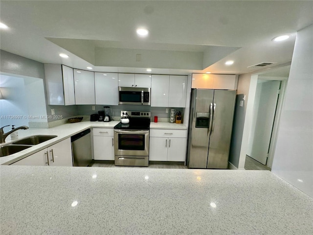 1000 Parkview Dr Unit 202, Hallandale Beach, FL 33009 - kitchen featuring light countertops, appliances with stainless steel finishes, a sink, and white cabinetry