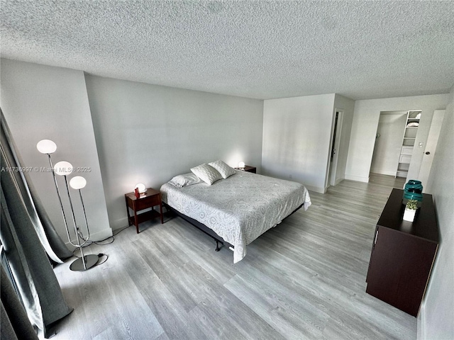 1000 Parkview Dr Unit 202, Hallandale Beach, FL 33009 - bedroom with a textured ceiling, wood finished floors, and baseboards