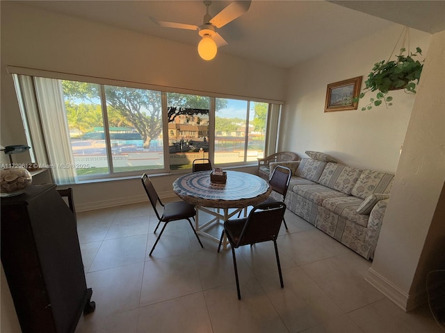 dining area with light tile patterned flooring and ceiling fan